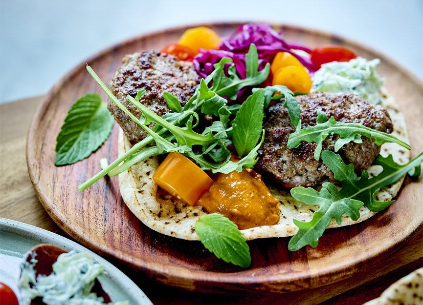 Spicy lamb burgers, harissa, tzatziki and grilled pita bread