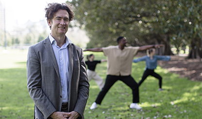 Professor Peter Kistler with yoga participants in background